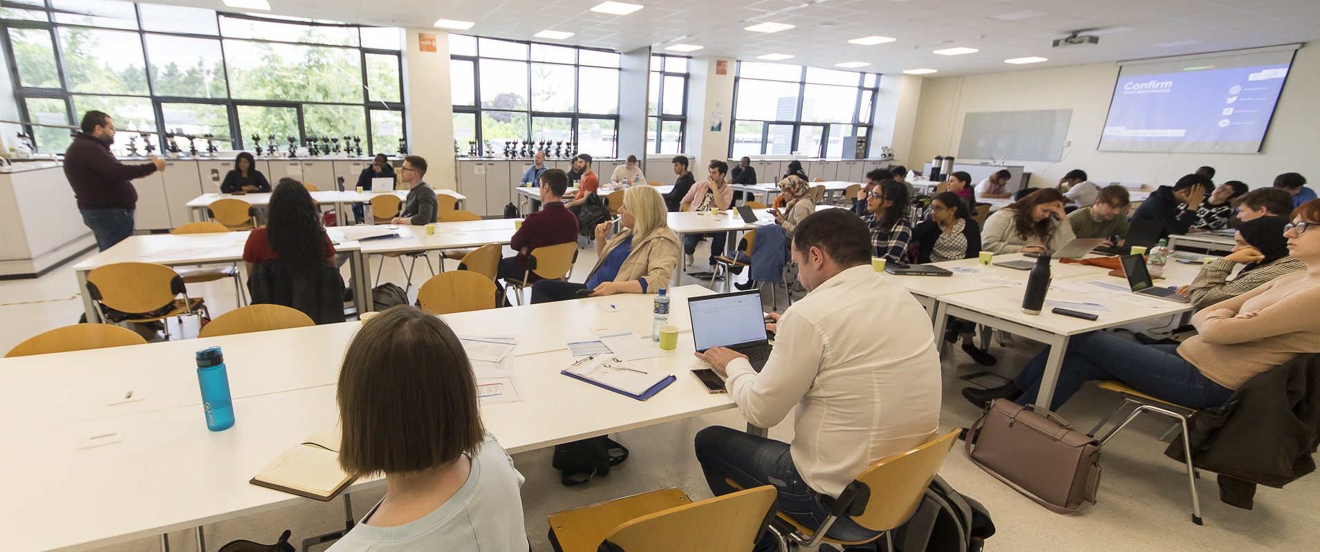 Staff sitting in a lecture viewing a presentation